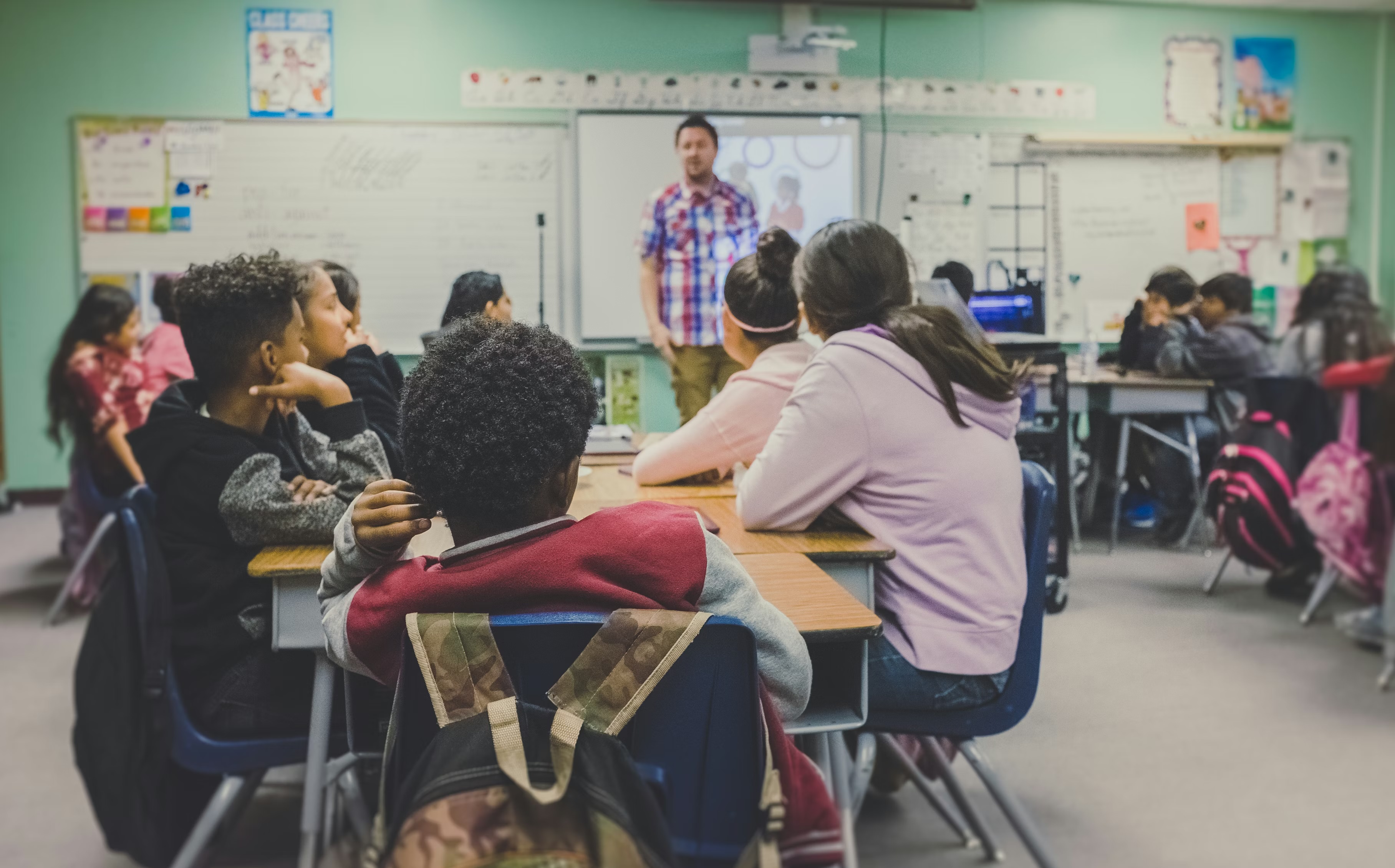Teacher reviewing lesson materials at their desk